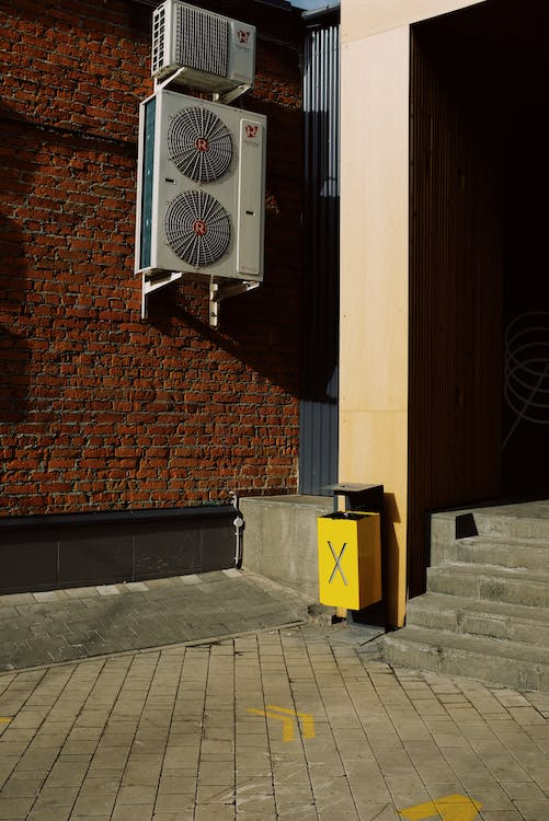 Outside airconditioning unit attached to the wall of a building