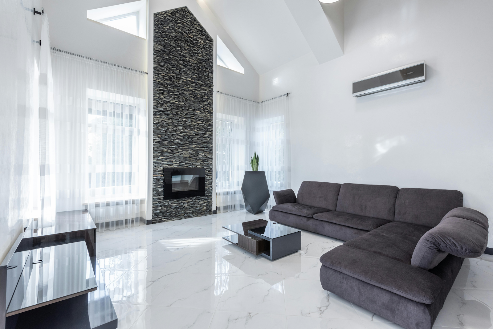 a living room in a house with an air conditioner on the wall