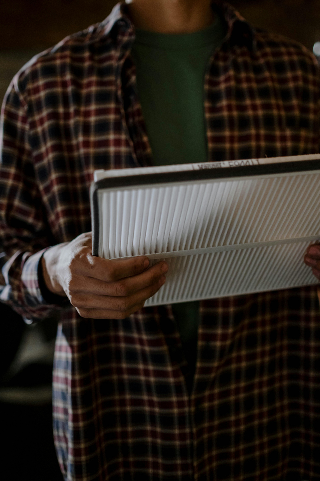 homeowner holding a new air filter