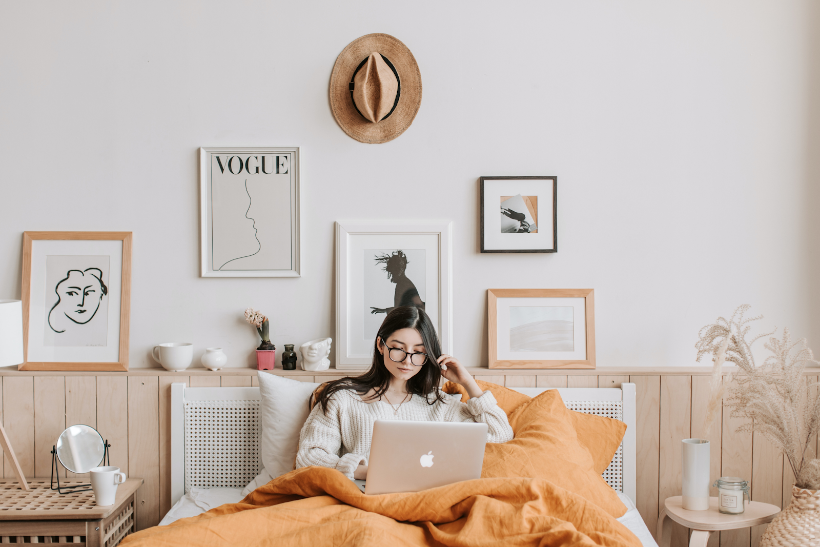 a woman on her laptop laying in bed learning what is bioheat