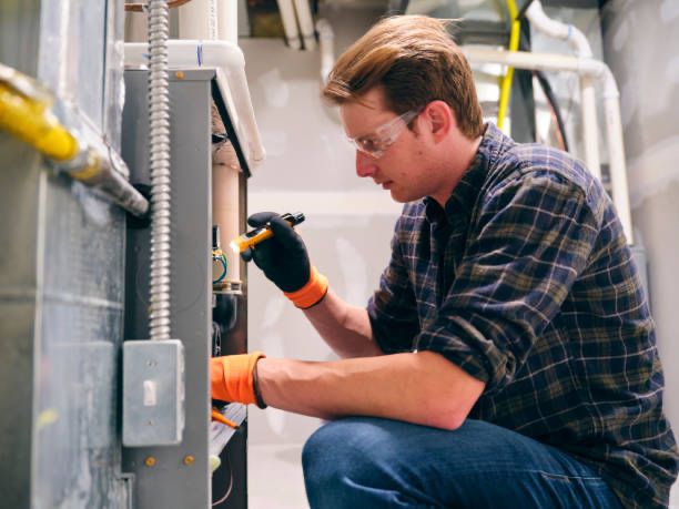 man fixing a furnace